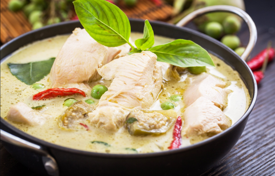 Delicious Crack Chicken served in a white plate garnished with green onions