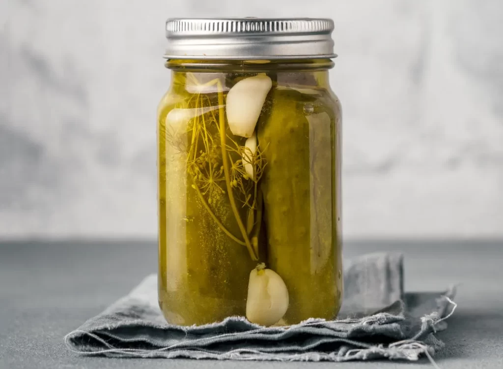 A jar of Annie's Recipes Sweet Amish Pickles, showcasing vibrant green pickles in a clear jar with a label.