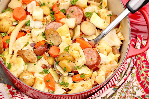 Freshly cooked cabbage and sausage in a skillet, showcasing vibrant colors and a tempting aroma