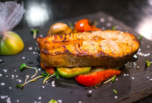 Freshly prepared branzino on a plate with lemon and herbs, illustrating a step-by-step branzino recipe.